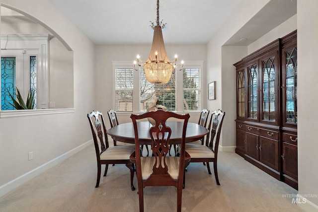 724 E Lakebrook Ln, Eagle, ID 83616 - dining room featuring light colored carpet, arched walkways, and a chandelier