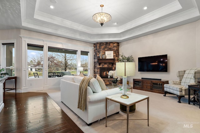 724 E Lakebrook Ln, Eagle, ID 83616 - living room featuring a tray ceiling, crown molding, a fireplace, hardwood / wood-style floors, and a chandelier
