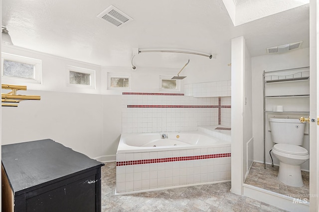 bathroom with visible vents, toilet, a tile shower, and a tub with jets