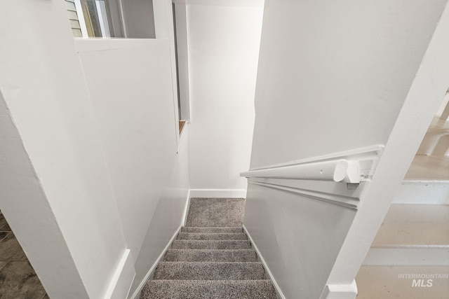 staircase featuring baseboards