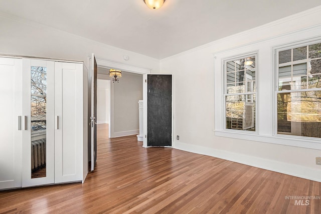 empty room with wood finished floors and a wealth of natural light