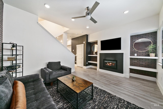 living room featuring ceiling fan and hardwood / wood-style floors