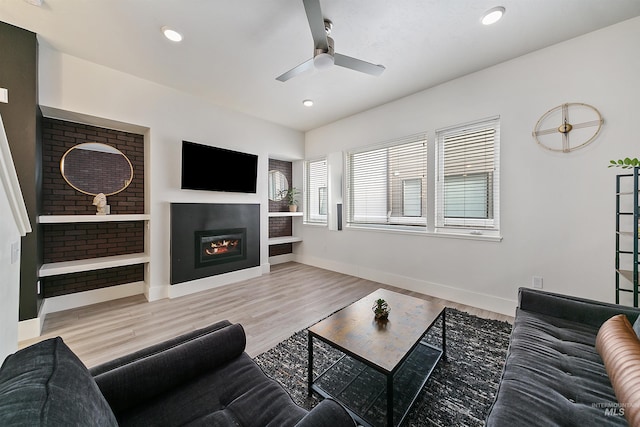 living room with ceiling fan and wood-type flooring