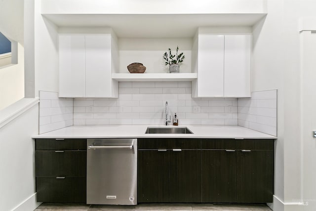 kitchen with decorative backsplash, white cabinetry, dark brown cabinets, and sink