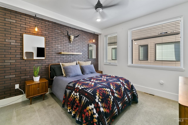 carpeted bedroom featuring brick wall and ceiling fan