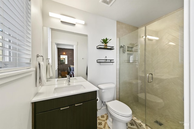 bathroom featuring toilet, walk in shower, and vanity