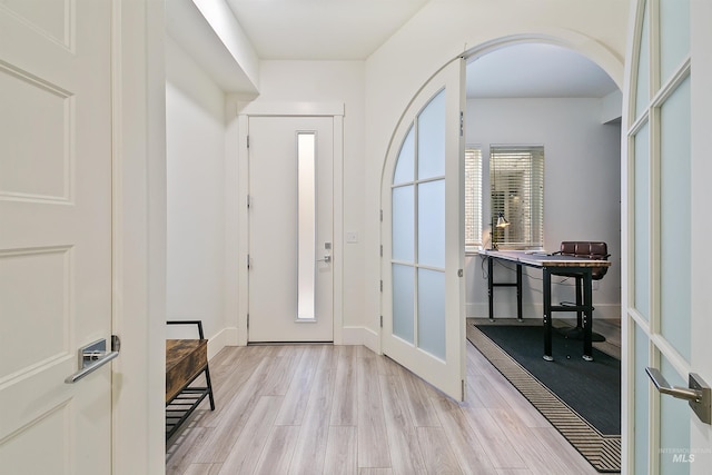 entrance foyer featuring french doors and light hardwood / wood-style floors