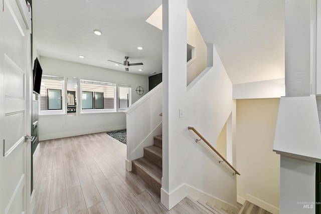 stairs with ceiling fan and wood-type flooring