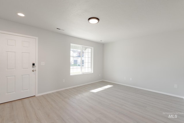 unfurnished room featuring light hardwood / wood-style flooring