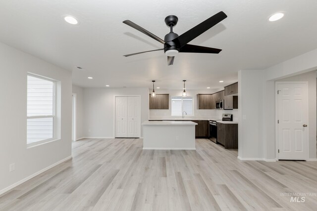 672 S Jayo Ct, Emmett, ID 83617 - kitchen featuring a center island, stainless steel appliances, light wood-type flooring, and sink