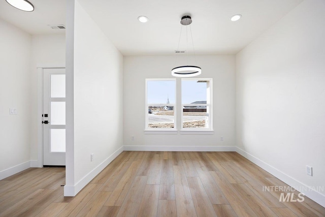 unfurnished dining area with recessed lighting, light wood-type flooring, visible vents, and baseboards