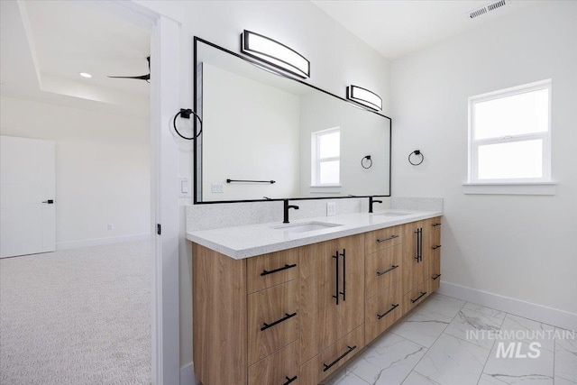 full bathroom featuring marble finish floor, a sink, visible vents, and baseboards