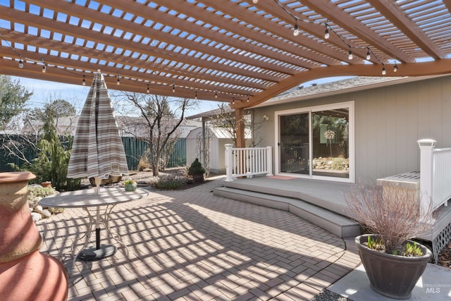 view of patio with a pergola, a storage shed, an outdoor structure, and fence