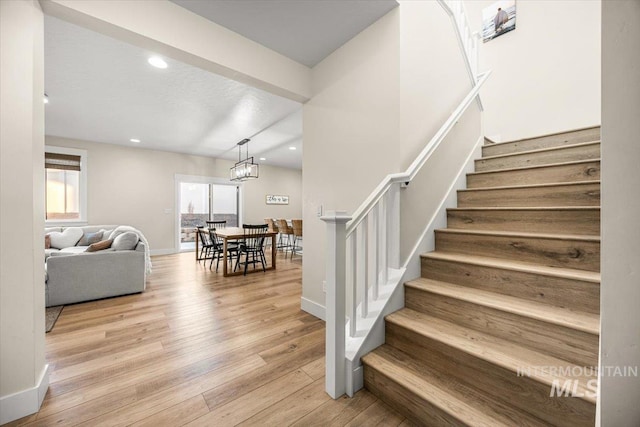 stairs with hardwood / wood-style floors