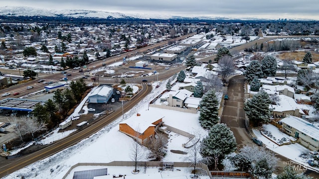 snowy aerial view with a mountain view