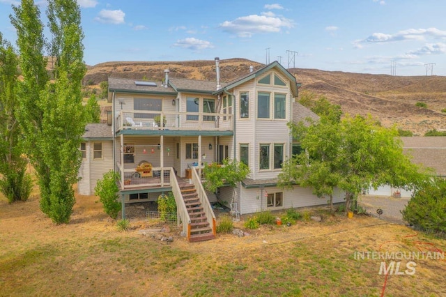 965 Horse Ln, Lewiston, ID 83501 - back of property with stairway, a balcony, and a deck with mountain view