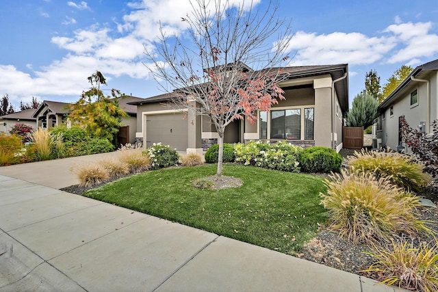 view of front of home featuring stucco siding, an attached garage, concrete driveway, and a front lawn