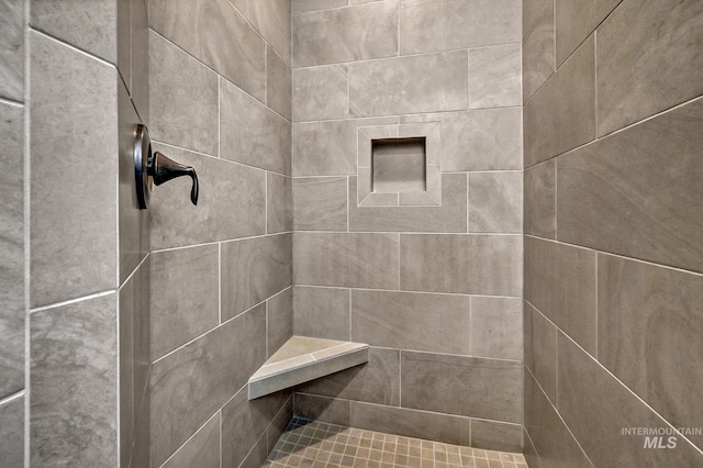 full bath with a tile shower