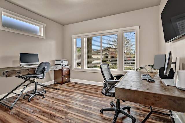 office area with a wealth of natural light, baseboards, and wood finished floors