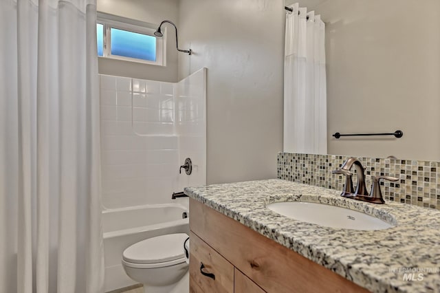 bathroom featuring shower / bath combination with curtain, backsplash, toilet, and vanity