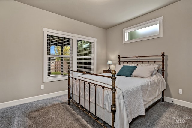 carpeted bedroom featuring baseboards