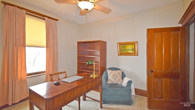 office area with a ceiling fan and wallpapered walls