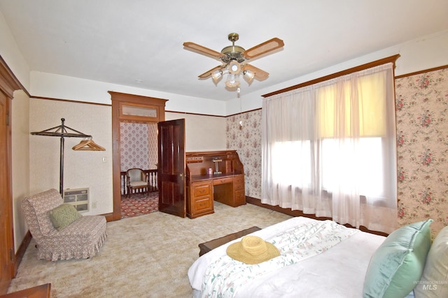 bedroom featuring light colored carpet, heating unit, and wallpapered walls