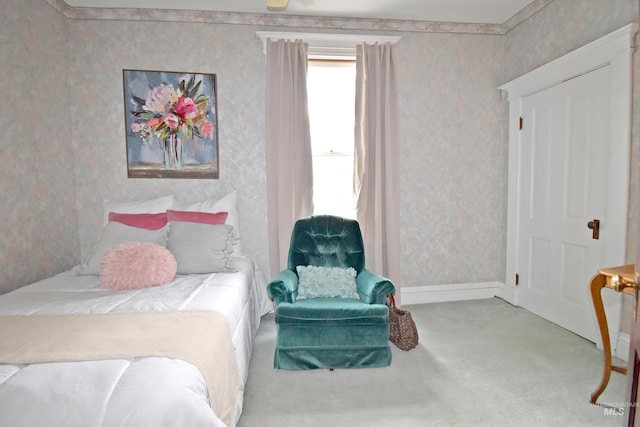 carpeted bedroom with crown molding, baseboards, and wallpapered walls