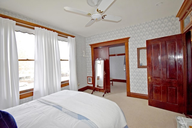 bedroom featuring baseboards, ceiling fan, light colored carpet, and wallpapered walls