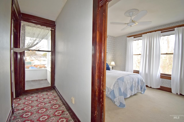 bedroom with light carpet, baseboards, and wallpapered walls