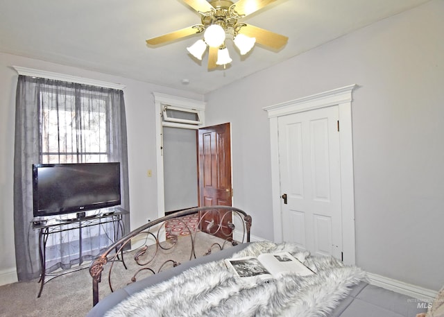 bedroom featuring a ceiling fan, a closet, and baseboards