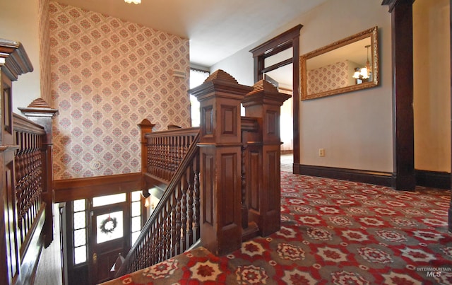 stairs featuring baseboards, carpet, and wallpapered walls