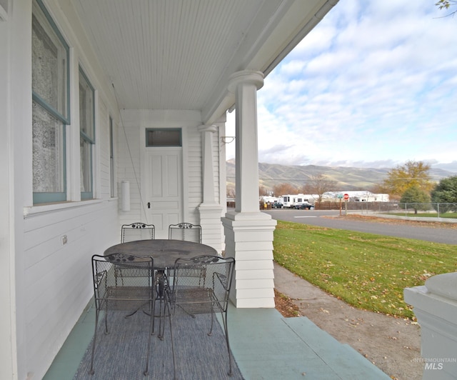 view of patio / terrace featuring a mountain view and outdoor dining area