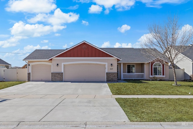 ranch-style home featuring a gate, fence, an attached garage, a front yard, and brick siding