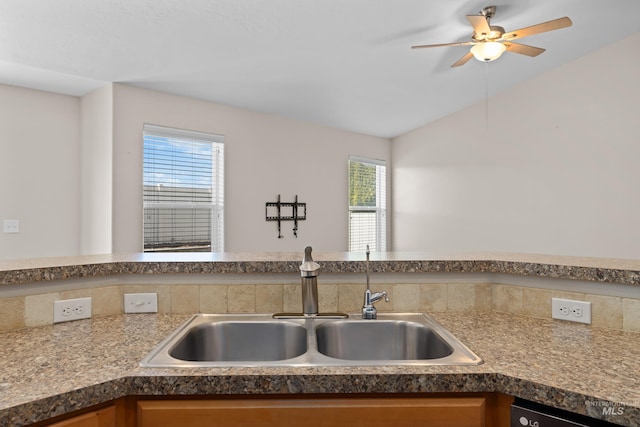 kitchen with vaulted ceiling, dishwasher, ceiling fan, and a sink