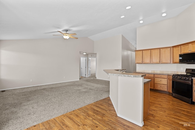 kitchen featuring ceiling fan, black microwave, open floor plan, carpet floors, and stainless steel gas stove