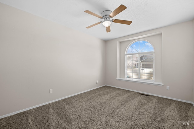 unfurnished room featuring visible vents, carpet flooring, baseboards, and ceiling fan