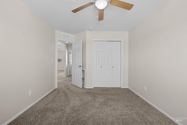 unfurnished bedroom featuring a closet, visible vents, carpet flooring, and baseboards