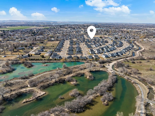 drone / aerial view with a water view and a residential view