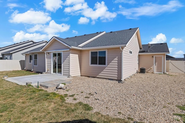 rear view of property with a patio, a lawn, central AC unit, and a fenced backyard