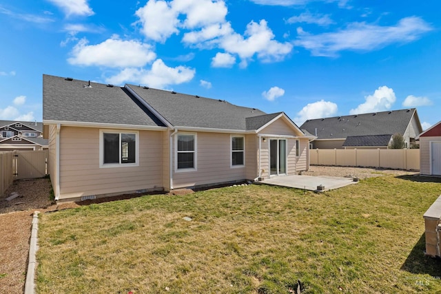 back of property with a patio, a fenced backyard, a lawn, and roof with shingles