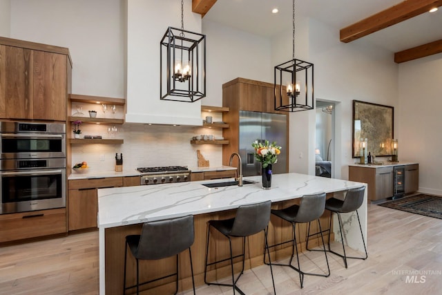 kitchen featuring stainless steel appliances, beverage cooler, a sink, and open shelves