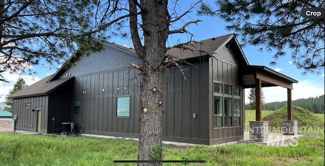 view of home's exterior featuring board and batten siding and cooling unit