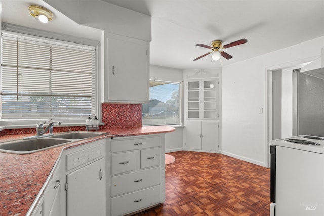 kitchen featuring white cabinets, white range with electric stovetop, ceiling fan, and sink