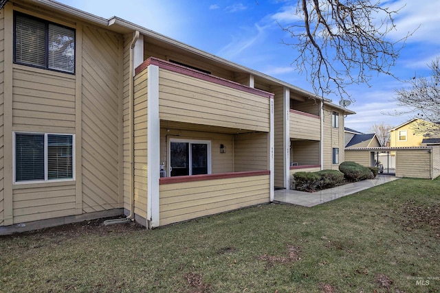 view of side of home with a lawn