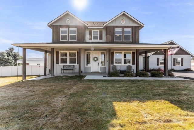 view of front of house featuring a front lawn, fence, a porch, and board and batten siding