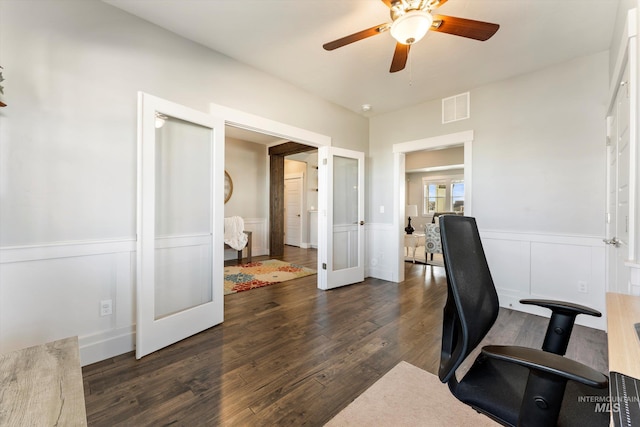 office featuring a wainscoted wall, visible vents, dark wood finished floors, and french doors