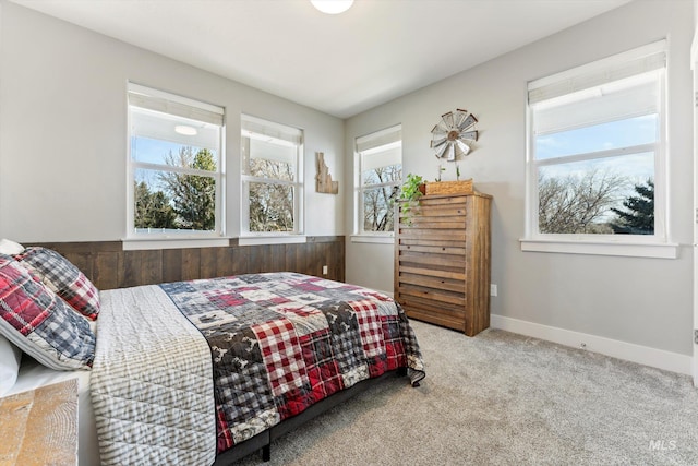 carpeted bedroom with multiple windows and baseboards