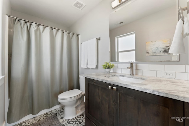 bathroom featuring visible vents, vanity, toilet, and tile patterned floors