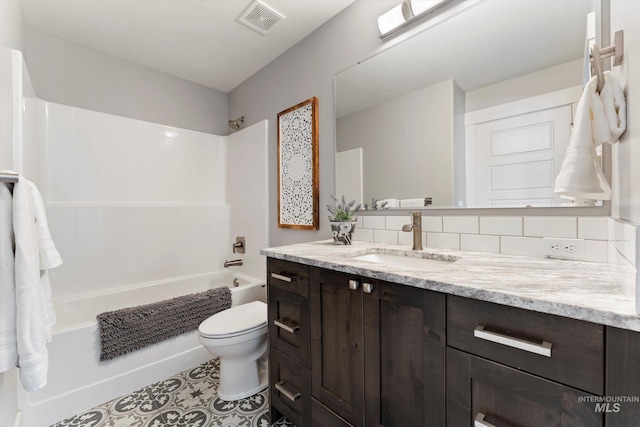 bathroom featuring visible vents, bathing tub / shower combination, toilet, vanity, and backsplash